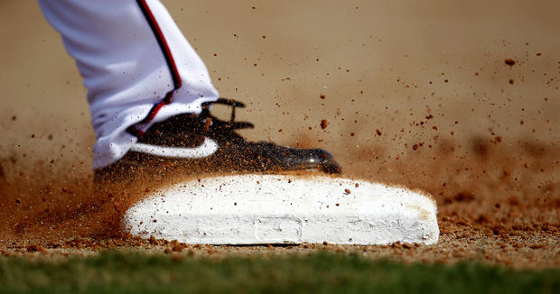 Dirt sprays as Washington Nationals pitcher Brad Lidge steps on first base 