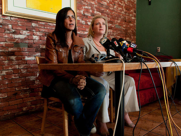 Carla Burgos, left, a sister of former "Survivor" producer Bruce Beresford-Redman's slain wife Monica, speaks as she is joined by her attorney during a news conference in L.A. on  Feb. 8, 2012. 