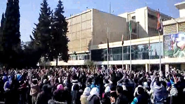 In this Wednesday, Feb. 22, 2012 citizen journalism image provided by the Local Coordination Committees in Syria and accessed on Thursday, Feb. 23, 2012, Syrian student protesters chant slogans, during a demonstration against Syrian President Bashar Assad 