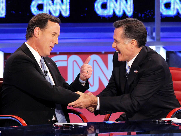Former U.S. Sen. Rick Santorum, left, and former Massachusetts Gov. Mitt Romney talk after participating in a debate sponsored by CNN and the Republican Party of Arizona at the Mesa Arts Center Feb. 22, 2012, in Mesa, Ariz. 
