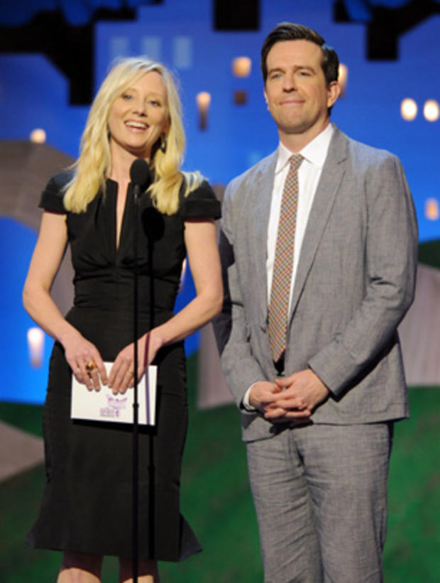 Ann Heche, left, and Ed Helms present an award onstage at the Independent Spirit Awards  