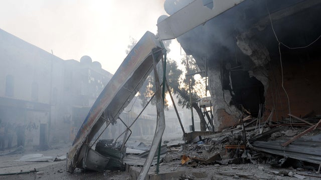 Smoke billows from a destroyed building 