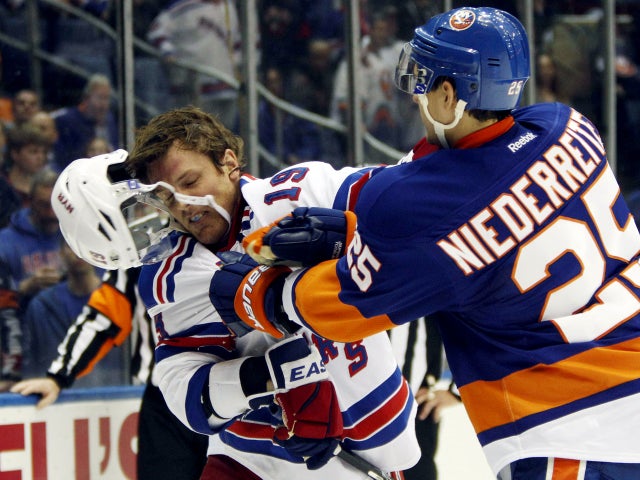 Nino Niederreiter takes a swing at center Brad Richards 