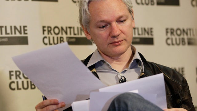 Julian Assange, founder of WikiLeaks looks at paperwork during a press conference in London, Monday, Feb. 27, 2012.  