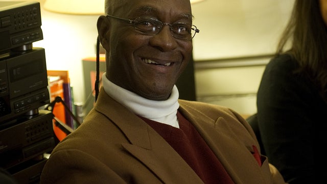 U.S. fugitive George Wright smiles as he sits between his lawyers in their office in Lisbon, Portugal, Nov. 17, 2011. 