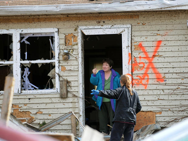 Margaret Shimkus, 61, talks with an emergency responder about her condition Wednesday, Feb. 29, 2012, at her home in Harrisburg, Ill., after an early morning tornado ripped through the town. 