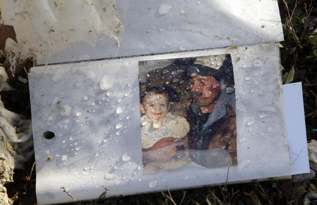 Water covers a family photo at the home where a deadly tornado on Wednesday killed a woman 