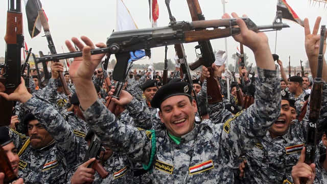 Iraqi police cadets celebrate after their graduation ceremony 