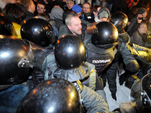 Police officers detain opposition activists at Moscow's Pushkinskaya Square March 5, 2012, as they refuse to leave the venue at the end of their larger rally earlier. 