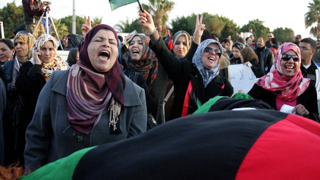 Libyan protesters wave their new national flag and shout slogans during a demonstration against decentralization and federalism in the eastern city of Benghazi March 5, 2012. 