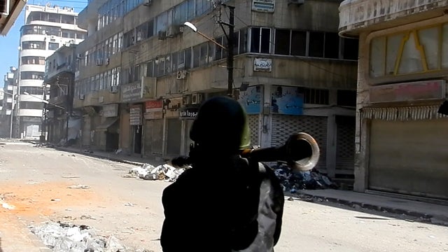 A man carries a rocket-propelled grenade in the al-Hamidiya neighborhood of the restive city of Homs, Syria, Feb. 25, 2012. 