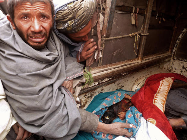 A mourner cries over the bodies of Afghan civilians 