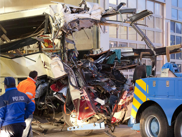 Wreckage of a tourist bus from Belgium is dragged by a tow truck outside a motorway tunnel 