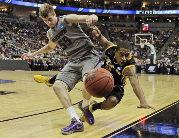 Southern Miss' Neil Watson, right, collides with Kansas State's Will Spradling 