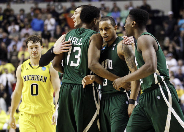 Ohio guard Walter Offutt, second from right, is congratulated by Ivo Baltic, fourth from right, T. J. Hall  
