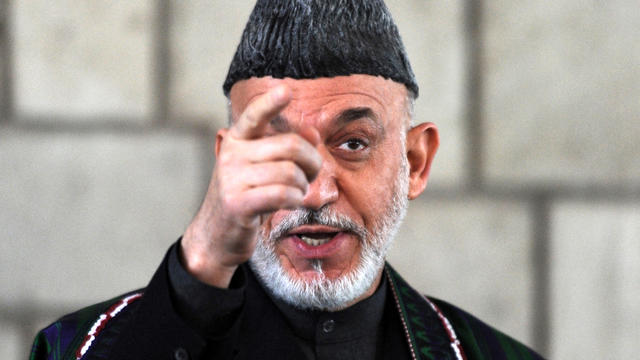 Afghan President Hamid Karzai gestures toward a journalist during a press conference at the presidential palace in Kabul, Afghanistan, March 6, 2012. 