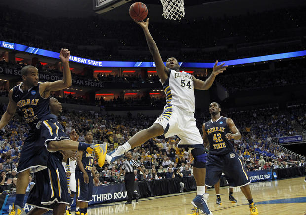 Marquette forward Davante Gardner goes to the basket as Murray State guard Jewuan Long 