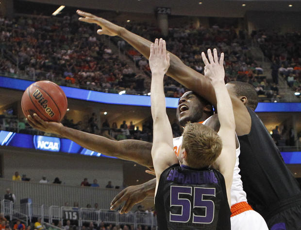 Syracuse's Dion Waiters, center, tries to shoot between Kansas State's Will Spradling (55) and Jordan Henriquez 