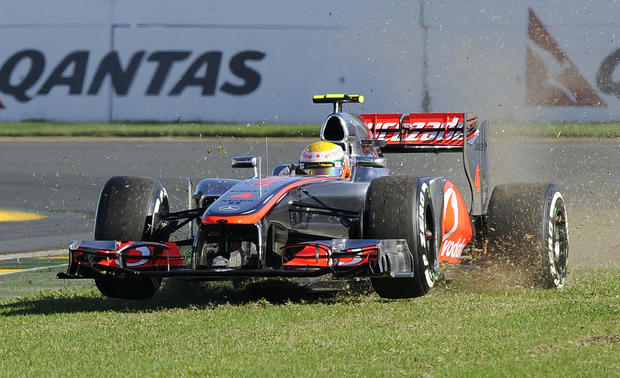 McLaren driver Lewis Hamilton of Britain runs off onto the grass 