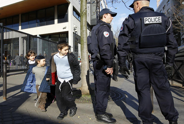French Police officers stand guard at the entrance of a Jewish school in Paris 