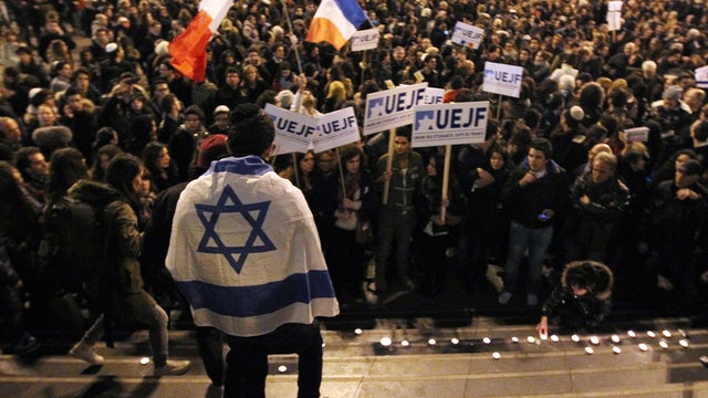 People take part in a march in Paris after a school shooting in Touli 
