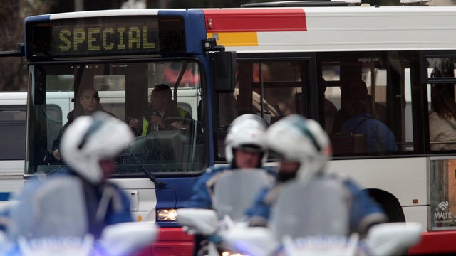 Police evacuate people in a bus as they leave their homes next to the building in Toulouse, France, March 21, 2012, where a suspect in the shooting at the Ozar Hatorah Jewish school has been spotted. 