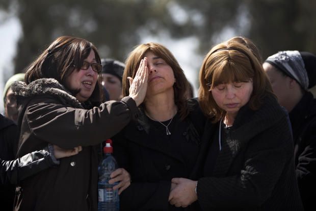 Family members react during a funeral for Toulouse shooting victims at a cemetery in Jerusalem March 21, 2012. 