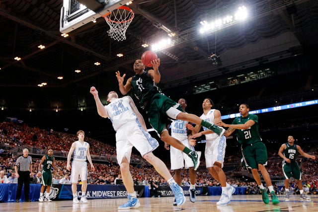 Reggie Keely shoots against Tyler Zeller  