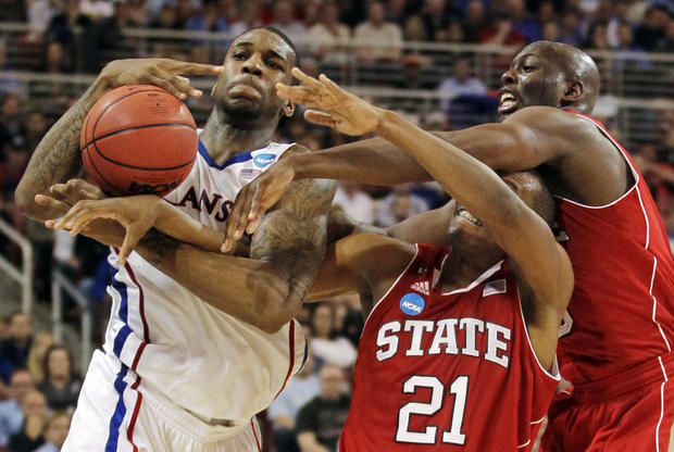 Thomas Robinson battles for a ball against C.J. Williams and center DeShawn Painter 