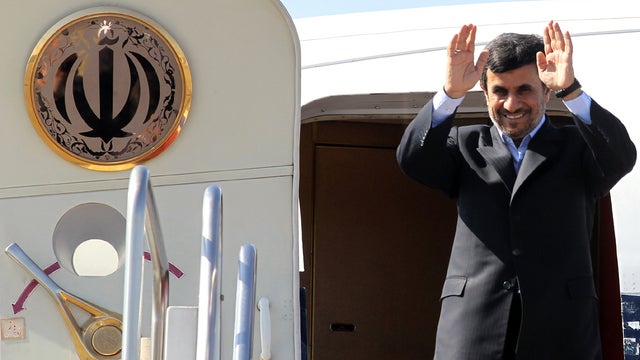 Iranian President Mahmoud Ahmadinejad waves prior to entering an airplane leaving Iran for Tajikistan at Tehran's Mehrabad airport March 24, 2012. 