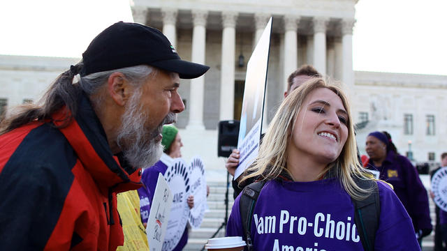 Richard Mondale yells at a Obama health care reform supporter during a protest in front of the U.S. Supreme Court building March 27, 2012, in Washington. 