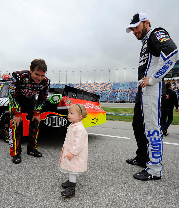 jason-smith-jeff-gordon-l-driver-of-the-24-dupont-chevrolet-and-jimmie-johnson-r-driver-of-the-48-lowes-kobalt-tools-chevrolet-look-at-jimmies-daughter-genevieve-marie.jpg 