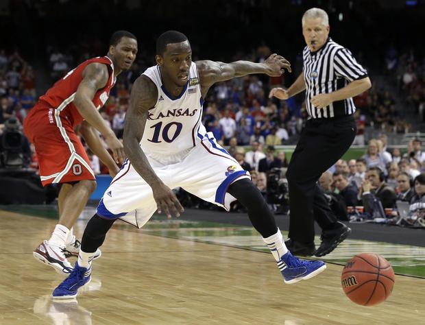 Tyshawn Taylor chases a loose ball  