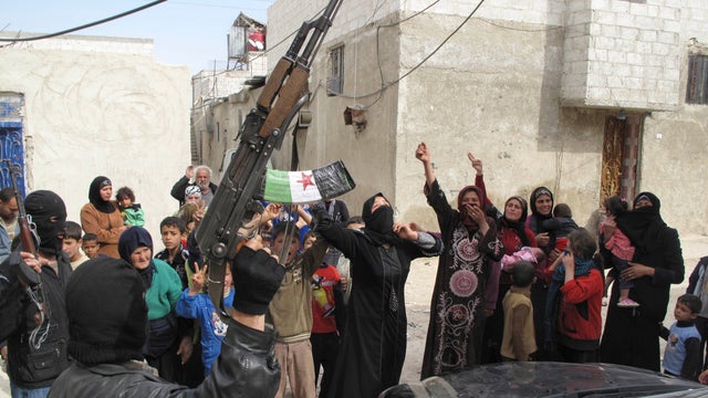 In this Sunday, April 1, 2012 photo, Syrians chant slogans against President Bashar Assad upon the arrival of the Free Syrian Army in a neighborhood of Damascus, Syria.  