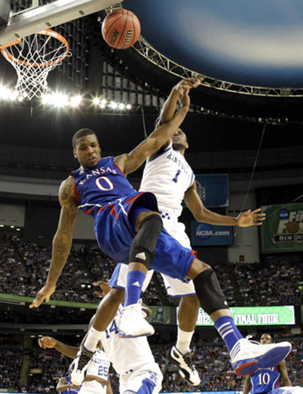 Thomas Robinson and Darius Miller battle for the ball  