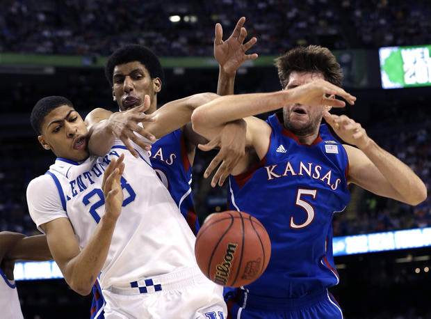 Kentucky forward Anthony Davis (23) battles for the ball with Kansas center Jeff Withey 