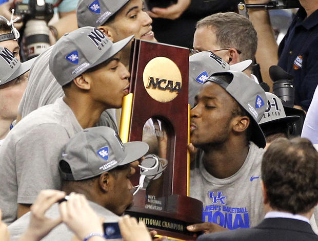 Anthony Davis, left, and  Michael Kidd-Gilchrist, right, kiss the trophy  