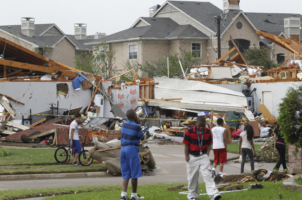 Neighbors view what remains of a home in Arlington, Texas 