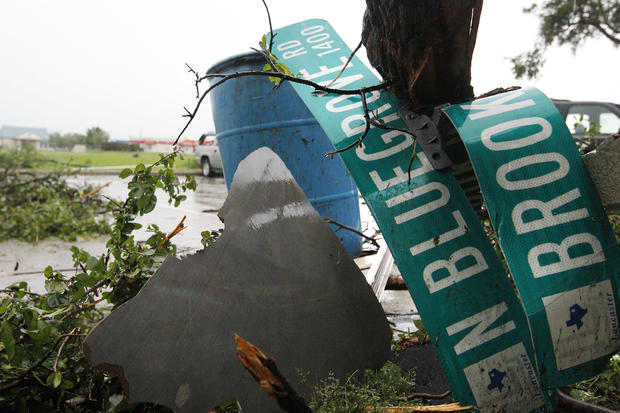 Streets signs from an adjacent neighborhood lay among the rubble of the heavily damaged Portofino Apartments in Lancaster 