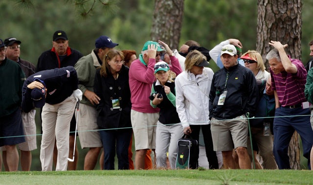 Padraig Harrington, of Ireland, and surrounding gallery on the first fairway duck 