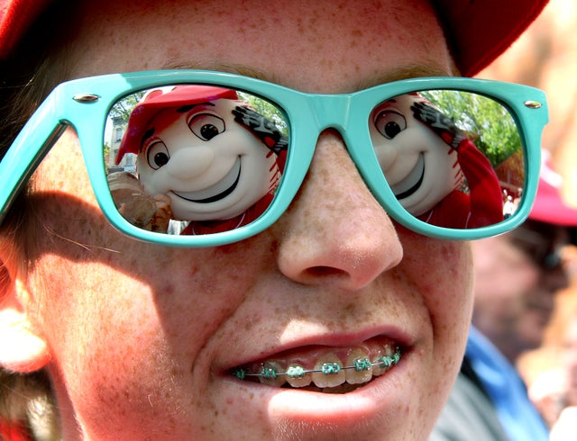 Lindsey Hubbard smiles at Mr Red, one of the Cincinnati Reds mascots 