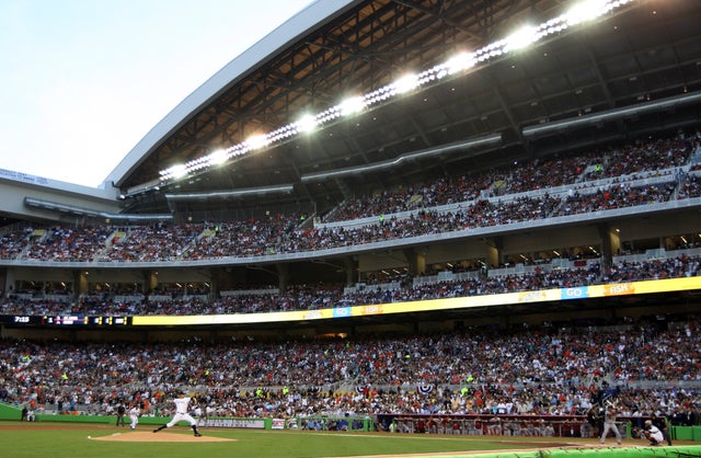 Miami Marlins starting pitcher Josh Johnson, left, throws the first pitch of the regular season  