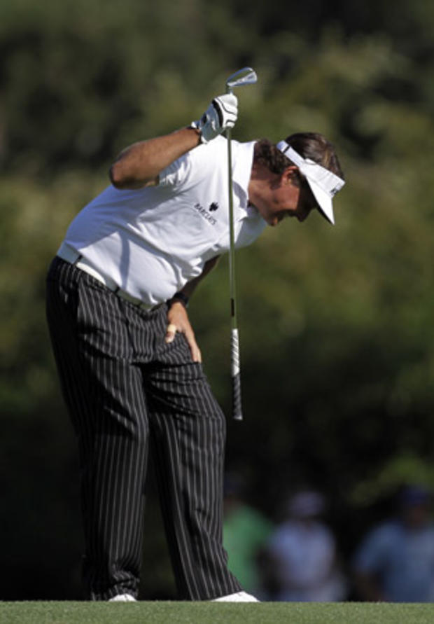 Phil Mickelson slams his club on the 15th fairway 