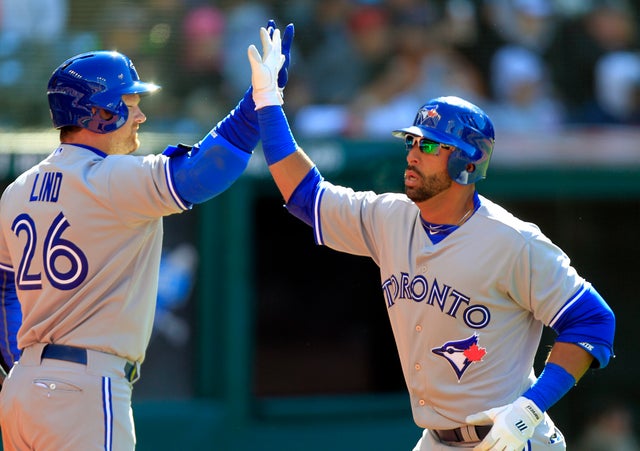 Jose Bautista is greeted by Adam Lind  