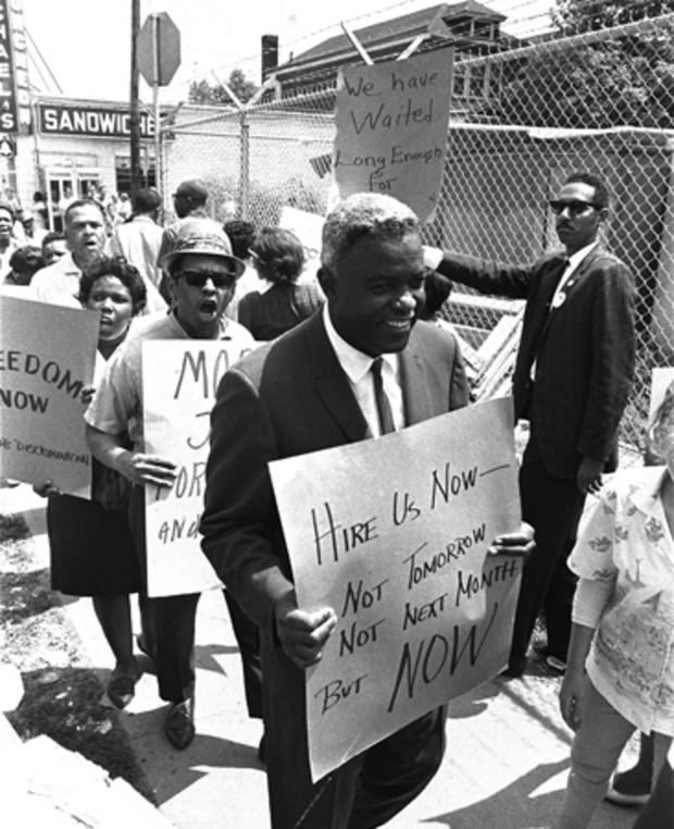 Robinson carries a placard as he joins pickets at the construction site of the Down State Medical Center in Brooklyn 