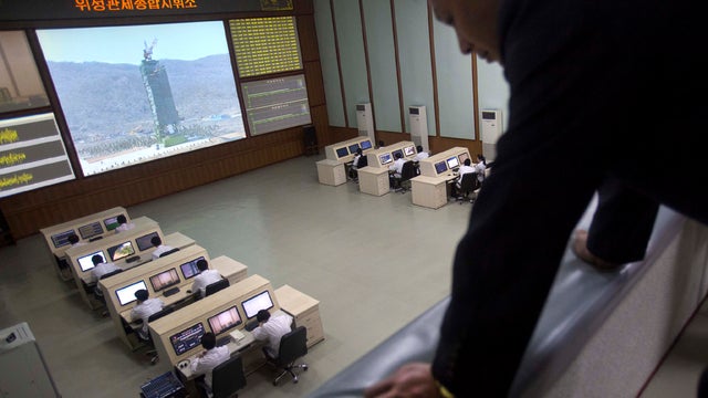 A North Korean man looks down from a balcony at the General Launch Command Center for North Korea's space agency on the outskirts of the capital city of Pyongyang April 11, 2012. 