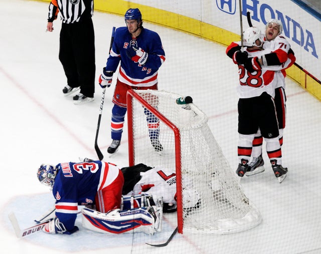 Nick Foligno hugs teammate Zenon Konopka after scoring a goal  