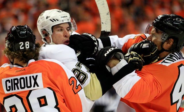 Claude Giroux holds on to Sidney Crosby as Kimmo Timonen lands a punch  