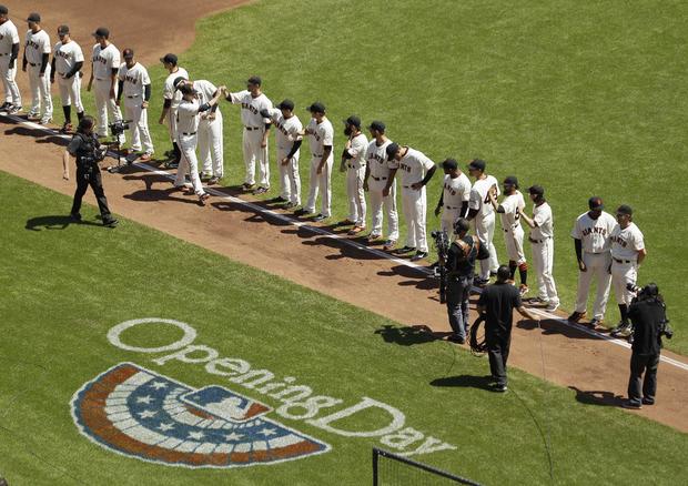 Buster Posey is greeted by teammates during introductions 