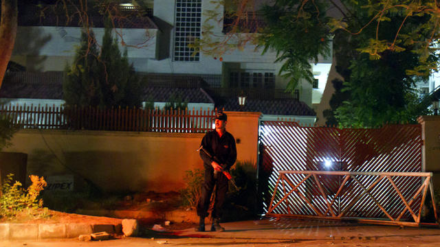 A Pakistani police commando stands guard outside a house where the family of late al Qaeda leader Osama bin Laden is believed to be held in Islamabad April 17, 2012. 
